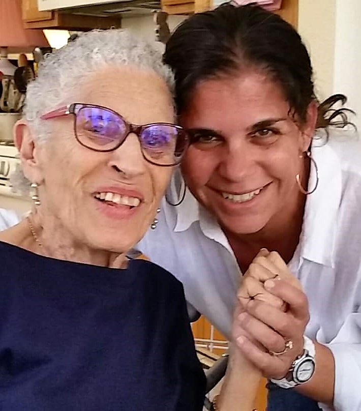 Image: Harriet smiling next to her mother, a JBI patron